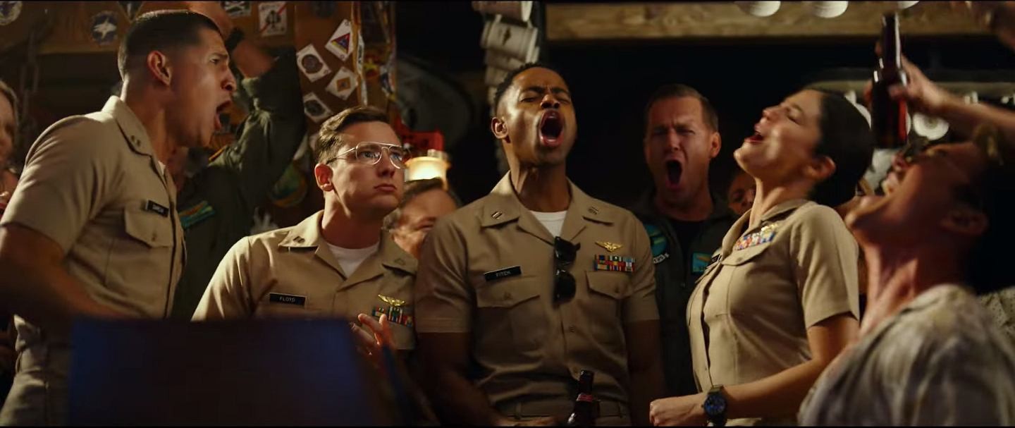 Pilots in uniform singing together around a piano
